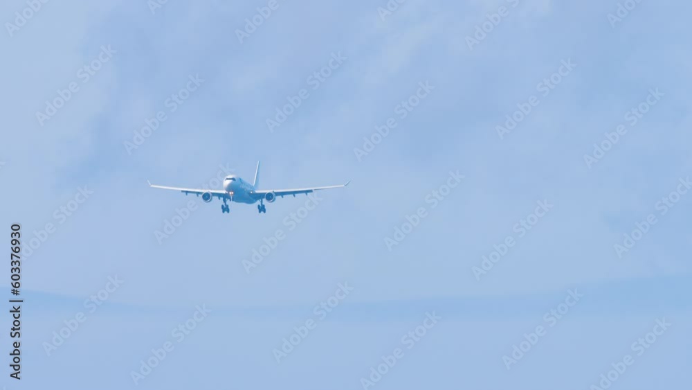 Jet plane landing approach, blue sky, long shot. Footage of a passenger airliner flying. Tourism and travel concept Jet plane landing approach, blue sky, long shot. Footage of a passenger airliner flying. Tourism and travel concept