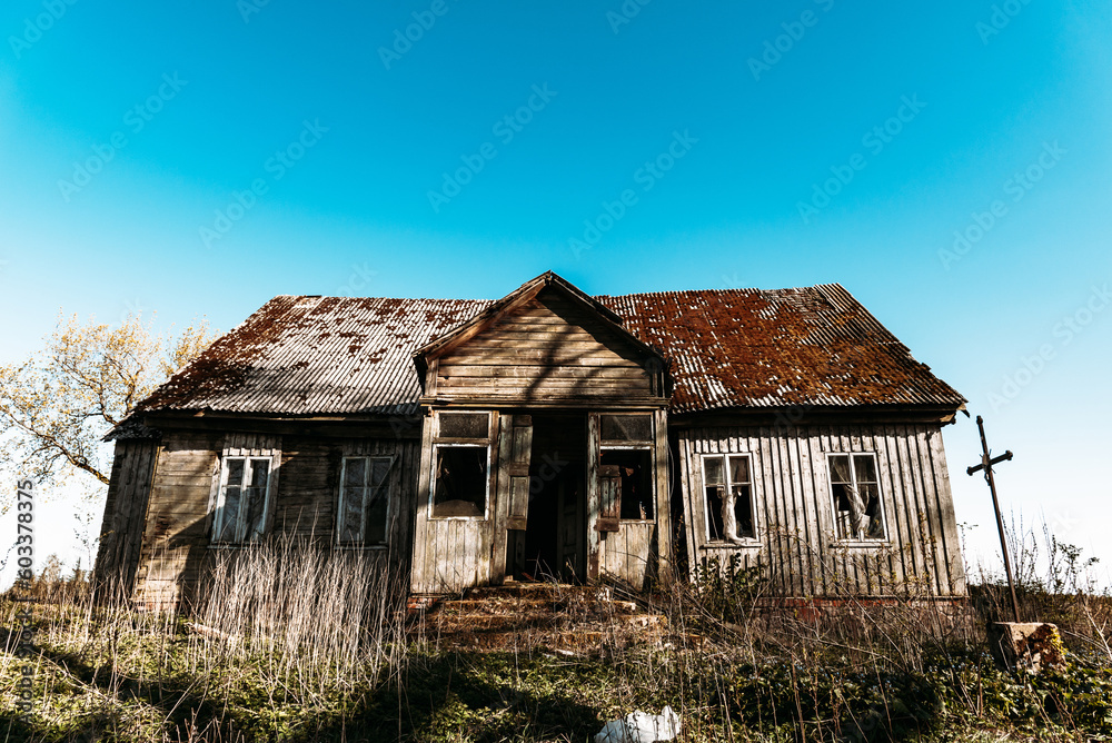 Abandoned 19th century house in a rural field at summer.Creepy summer evening. Abandoned 19th century house in a rural field at summer.Creepy summer evening.