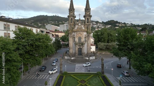 Aerial jib shot showing traffic around the historic Nossa Senhora da Consolacao e Santos Passos church (aka Sao Gualter church) in Guimaraes, Portugal. photo