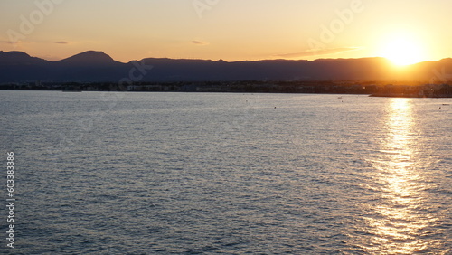 sunset over the water between mountains