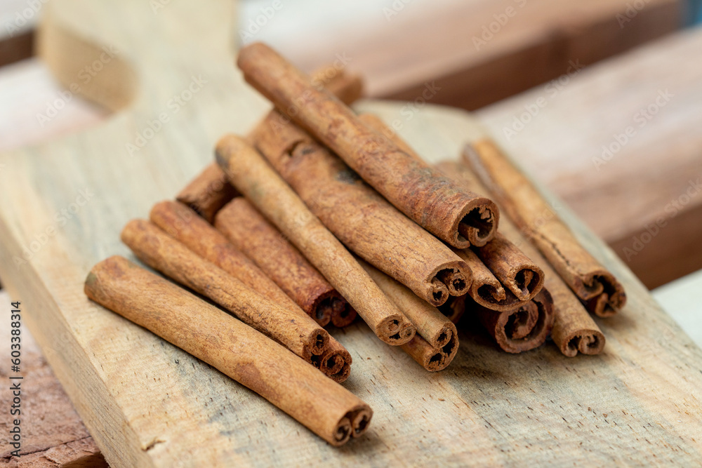 Cinnamon sticks on a wooden coaster on a wooden background Cinnamon sticks on a wooden coaster on a wooden background