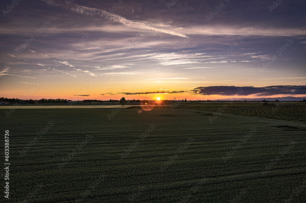 Orange Sunset Over Lush Fields in Northern Italy Orange Sunset Over Lush Fields in Northern Italy