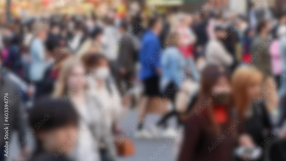 Blurred defocused view of the Shibuya Crossing in Japan becomes a hive of activity as countless people traverse the intersection during daylight hours. Blurred defocused view of the Shibuya Crossing in Japan becomes a hive of activity as countless people traverse the intersection during daylight hours.