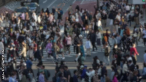 Wallpaper Mural Blurred defocused view of elevated view of a bustling crowd of people in the famous Shibuya Crossing in Japan during the daytime, densely packed and moving quickly through the streets.  Torontodigital.ca