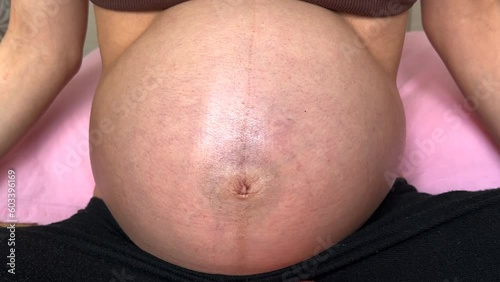 Pregnant woman belly  enjoying pregnancy. Future family, baby infant expecting child inside. Woman pregnancy concept and maternity prenatal care Natural light, 4K.