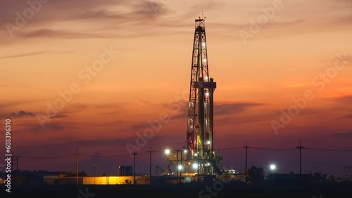 Sunset oil drilling rig in the field Time lapse