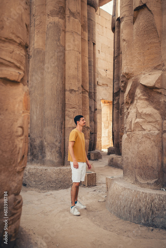 young male traveler visits Karnak temple in Luxor, Egypt