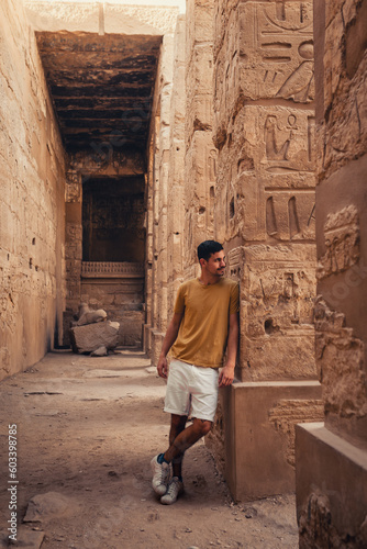young male traveler visits Karnak temple in Luxor, Egypt