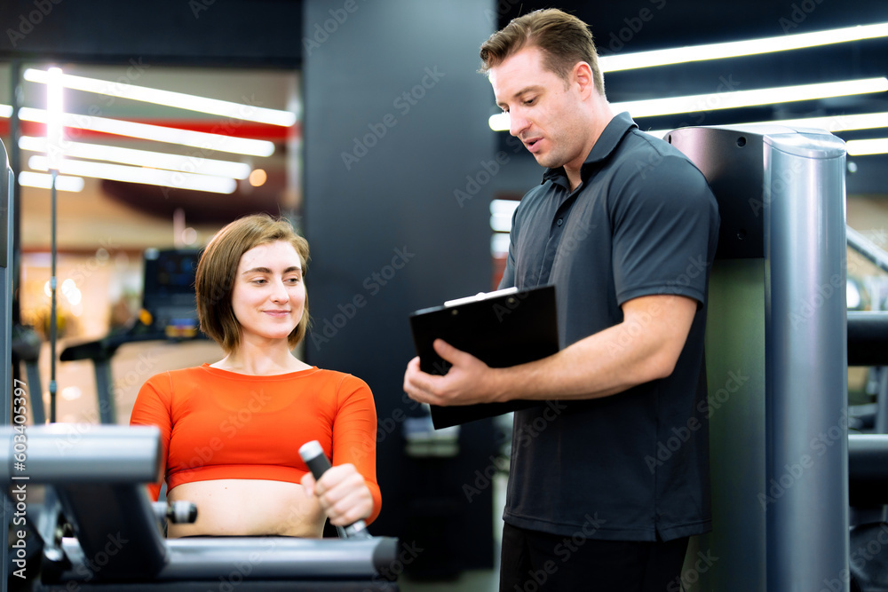 Caucasian woman exercising at gym with trainer. Caucasian woman exercising at gym with trainer.