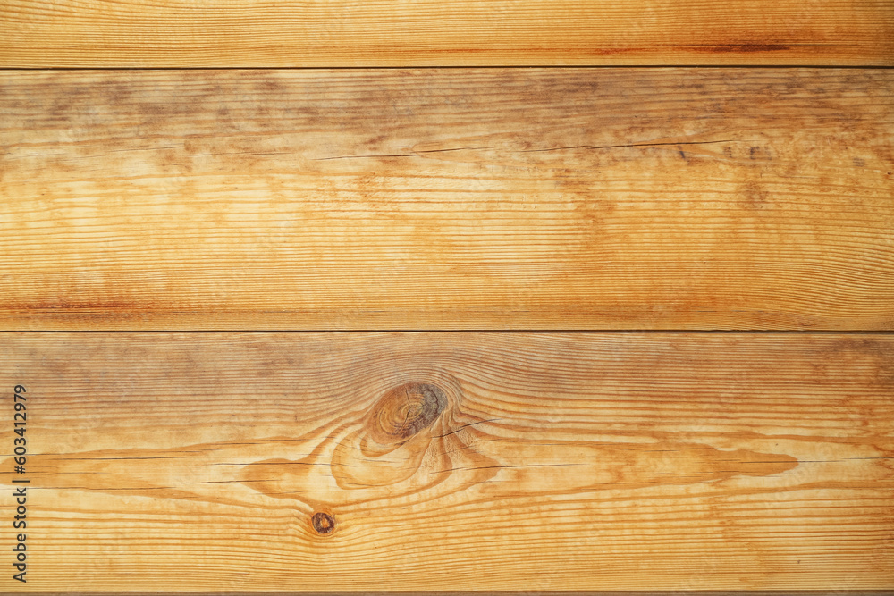 Wall made of yellow wooden panels with big knot and multiple cracks as a background Wall made of yellow wooden panels with big knot and multiple cracks as a background