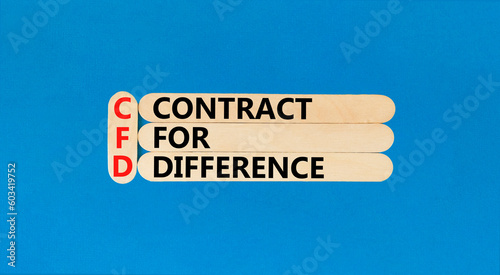 CFD symbol. Concept words CFD contract of difference on beautiful wooden sticks. Beautiful blue table blue background. Business and CFD contract of difference concept. Copy space.