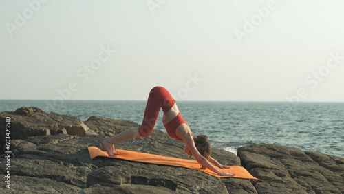 Girl practicing yoga in a downward facing dog pose