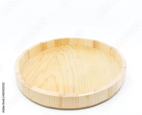 One empty round wooden tray, isolated on white background with copy space. photo