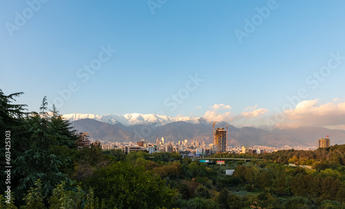 Skyline and cityscape of northern Tehran and Alborz mountain range viewed from the pedestrian Tabiat Bridge in Tehran, Iran.
