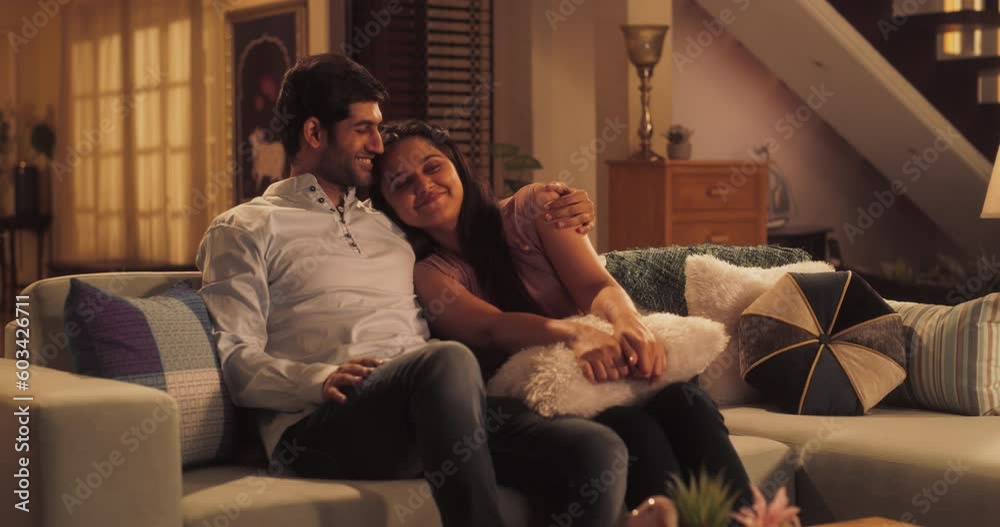 Movie Night: Young Couple Relaxing on the Couch, Watching Exciting Movie on TV. Girlfriend and Boyfriend Embrace, Cuddle, Talk, Smile and watch Television Streaming Services in Cozy Home. Static Shot Movie Night: Young Couple Relaxing on the Couch, Watching Exciting Movie on TV. Girlfriend and Boyfriend Embrace, Cuddle, Talk, Smile and watch Television Streaming Services in Cozy Home. Static Shot