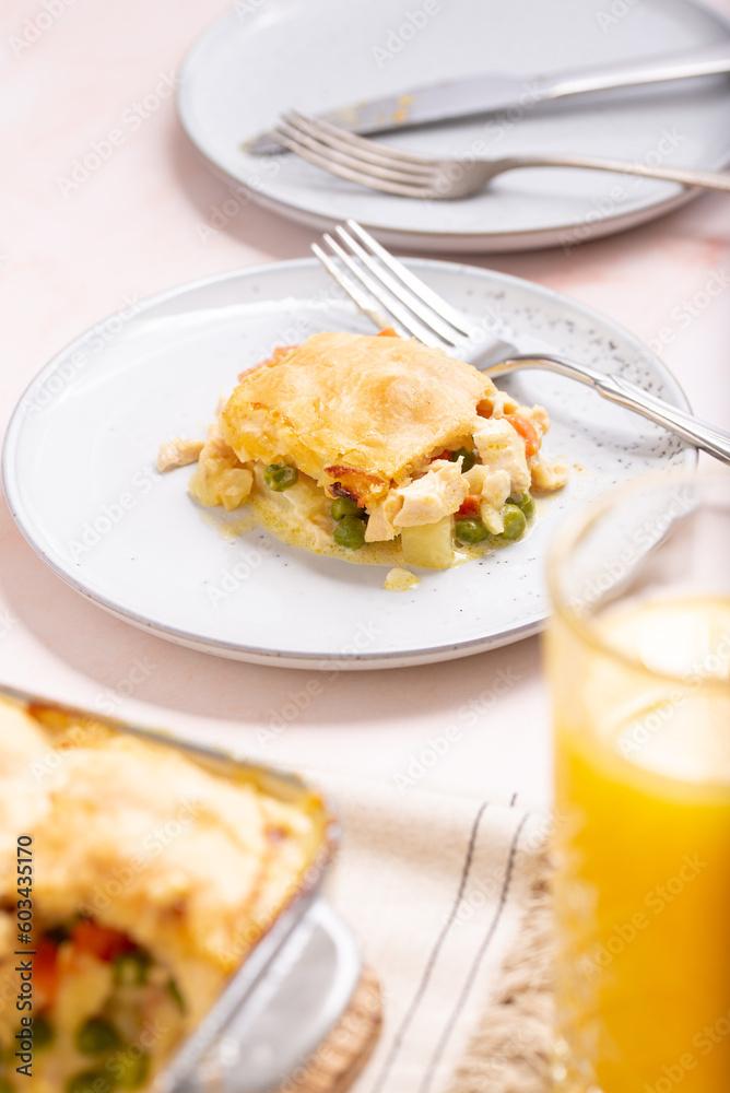 Pie on a Plate: Comforting Homestyle Chicken Pot Pie, A Classic Family Favorite with Flaky Golden Crust, Succulent Poultry, Vibrant Vegetables, and a Creamy Herb-infused Filling, Baked dish