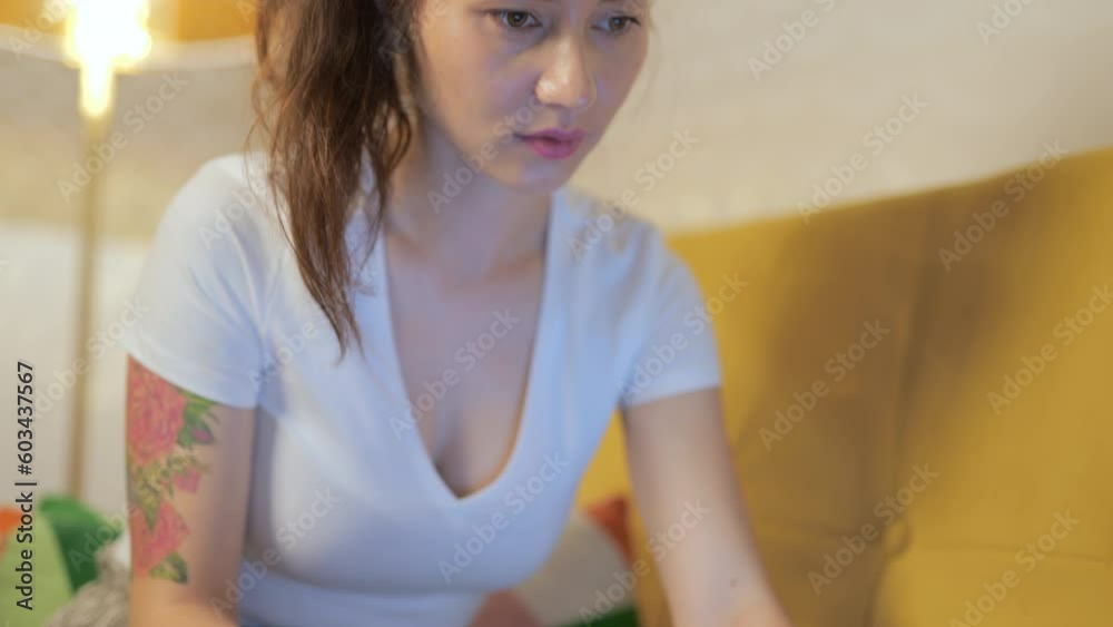 E-banking app service. Smiling young woman customer holding credit card sitting on couch at home with laptop. Happy female shopper using instant easy mobile payments making purchase in online store. E-banking app service. Smiling young woman customer holding credit card sitting on couch at home with laptop. Happy female shopper using instant easy mobile payments making purchase in online store.