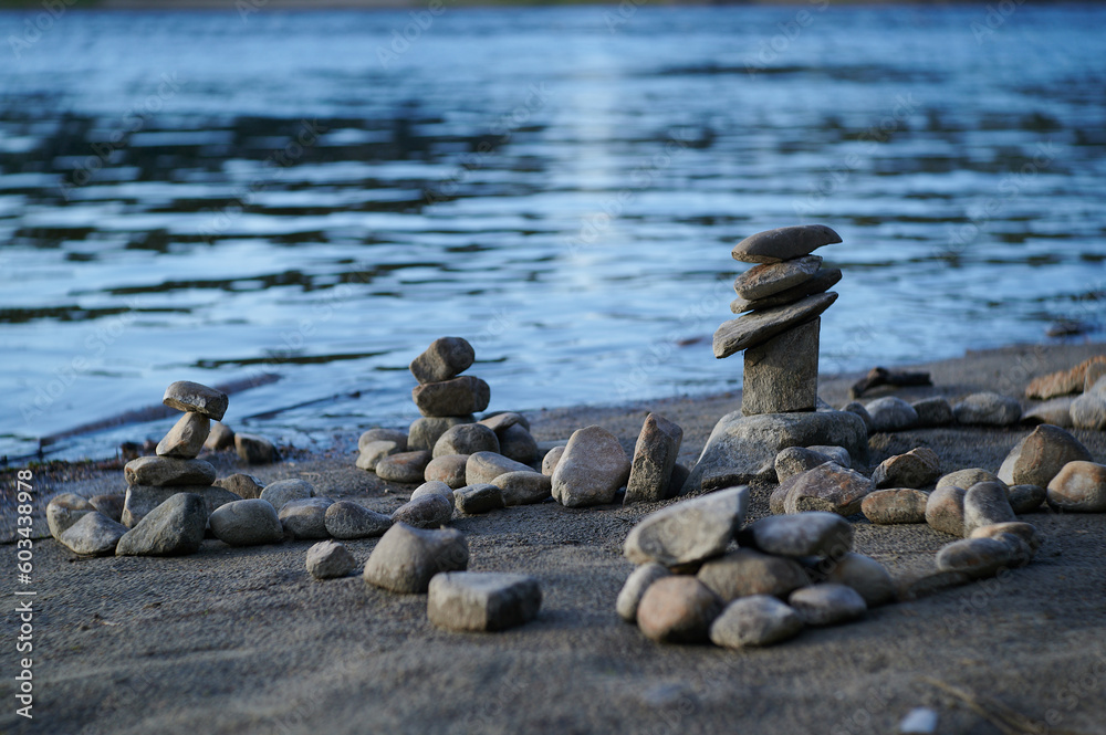 a pile of rocks sitting next to a body of water a pile of rocks sitting next to a body of water