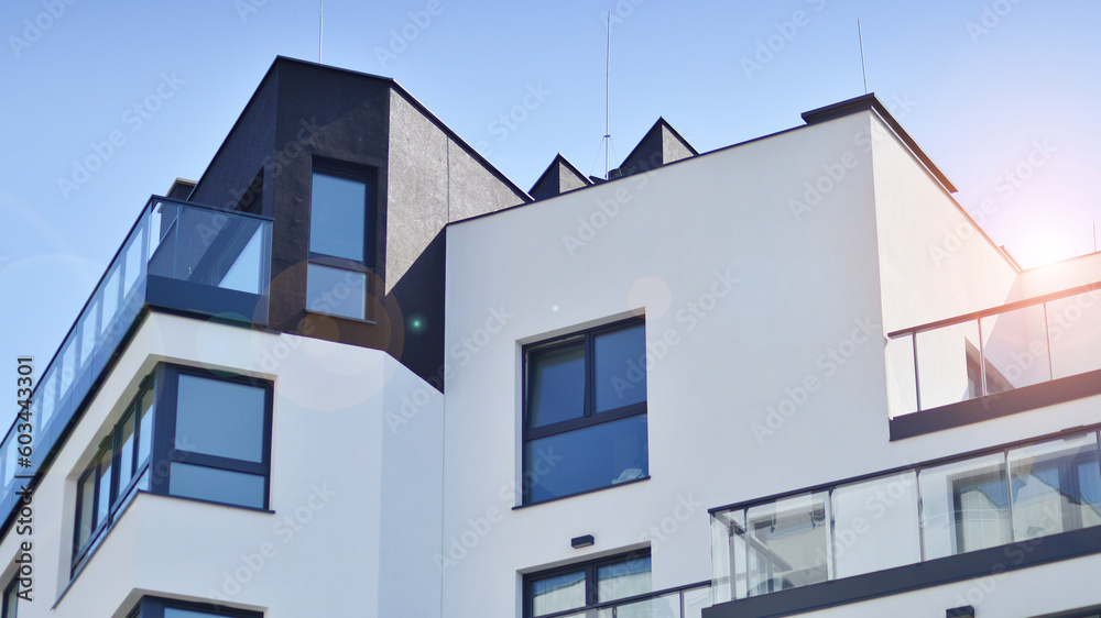 Apartment building with bright facades. Modern minimalist architecture with lots of square glass windows and balconies.