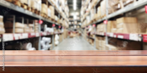 Empty wooden table, blur storage warehouse shelves background. .