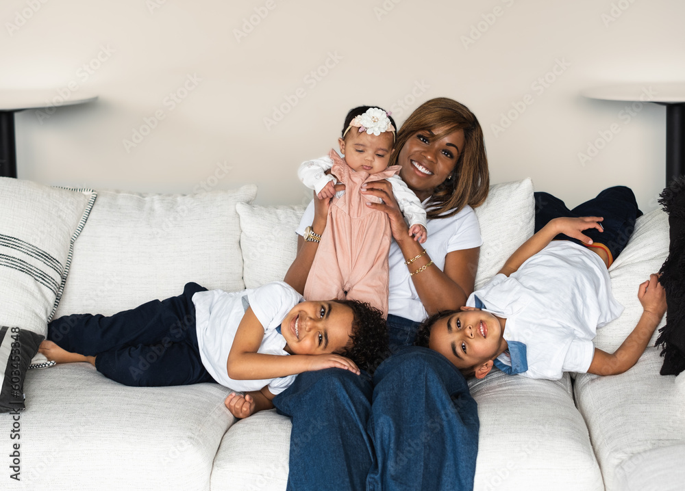 Beautiful African American woman lifting her baby girl; her six year ...