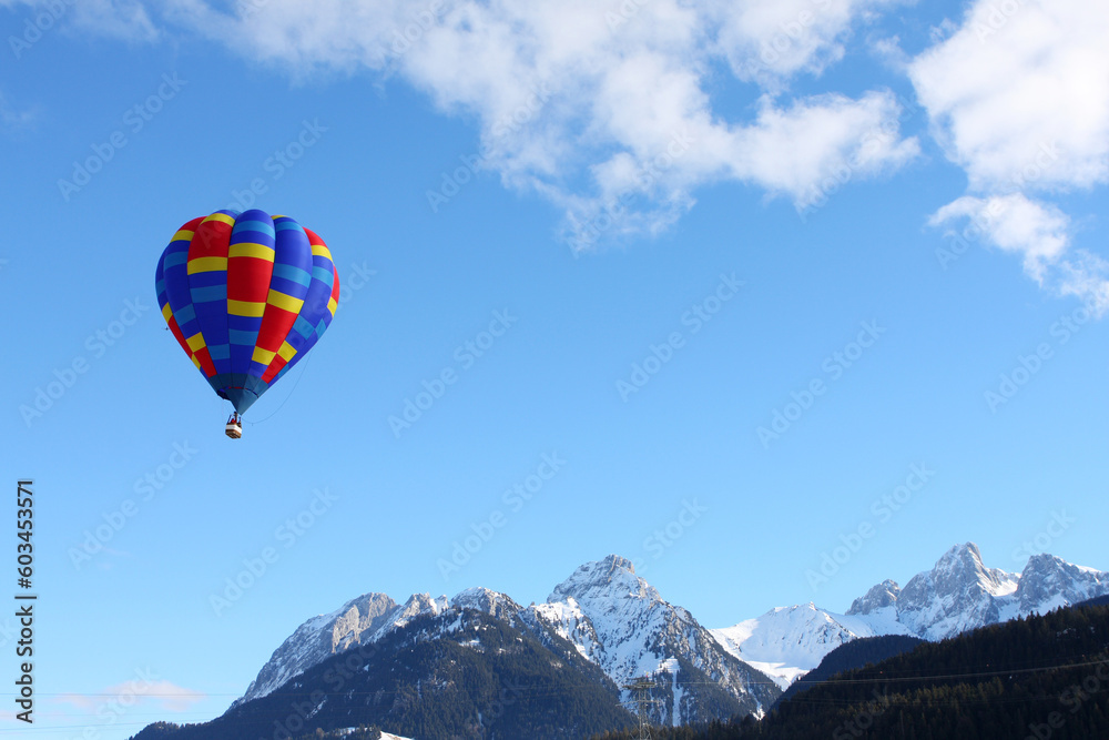 Fototapeta premium Colorful hot air balloon flying against a blue sky background