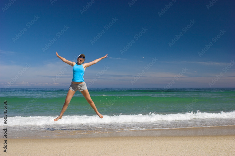 Beautiful young woman jumping on a beautiful beach Beautiful young woman jumping on a beautiful beach