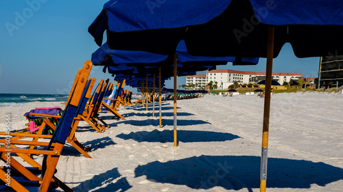 Blue Umbrellas and chairs at Ft Walton Beach Fl., Blue sky and soft sand beach.