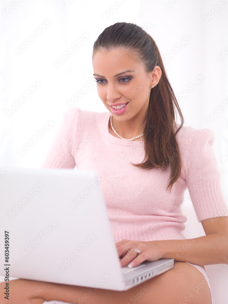 Young pretty women on white couch relaxing and using laptop computer Young pretty women on white couch relaxing and using laptop computer