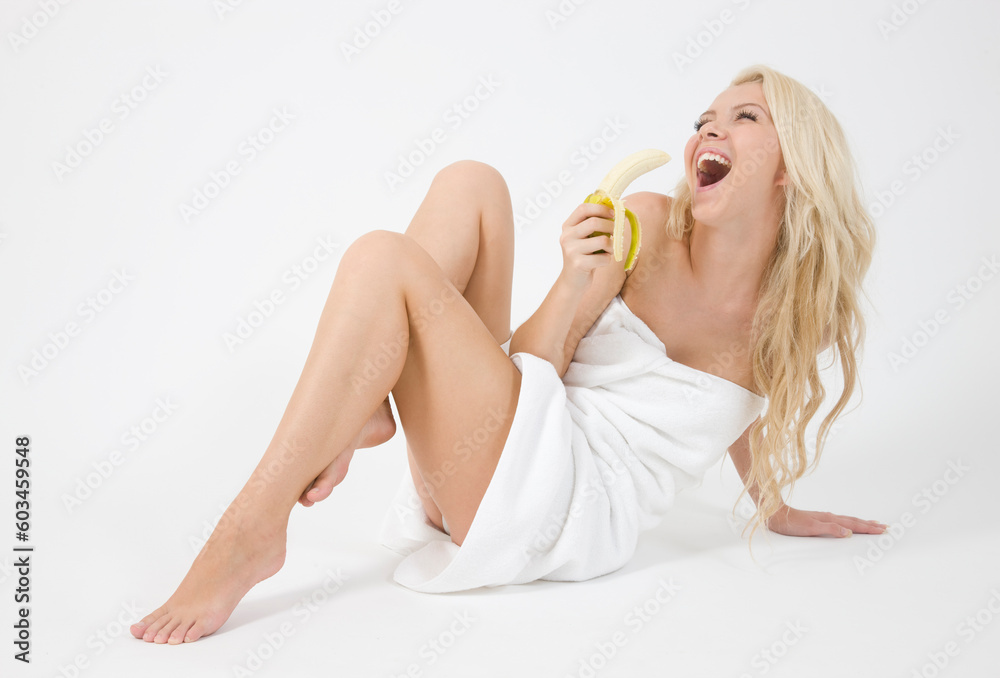 Naklejka premium nice blonde woman holding banana on white background