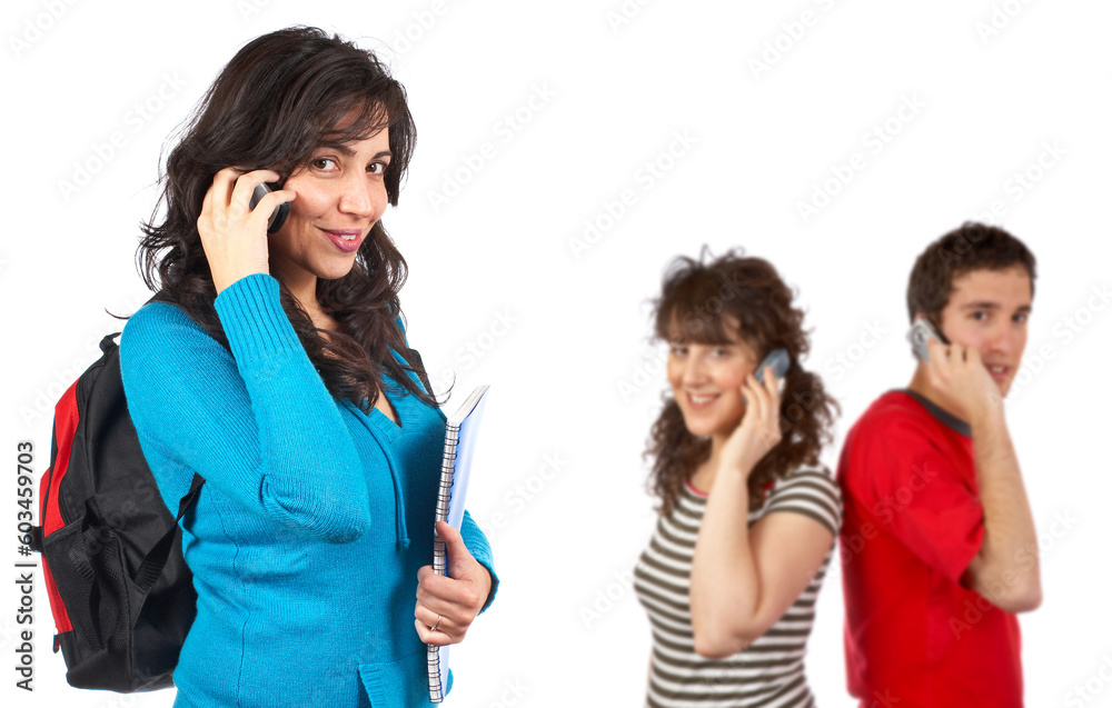 Three students with books and backpacks over a white background. Focus at front Three students with books and backpacks over a white background. Focus at front