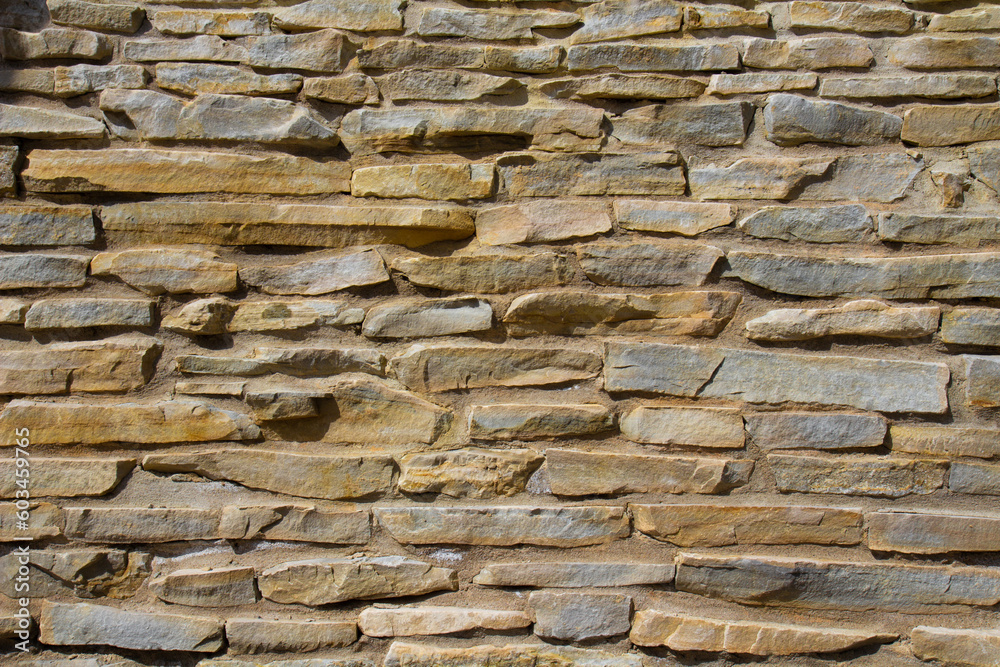 Fototapeta premium The stone wall texture background natural color.