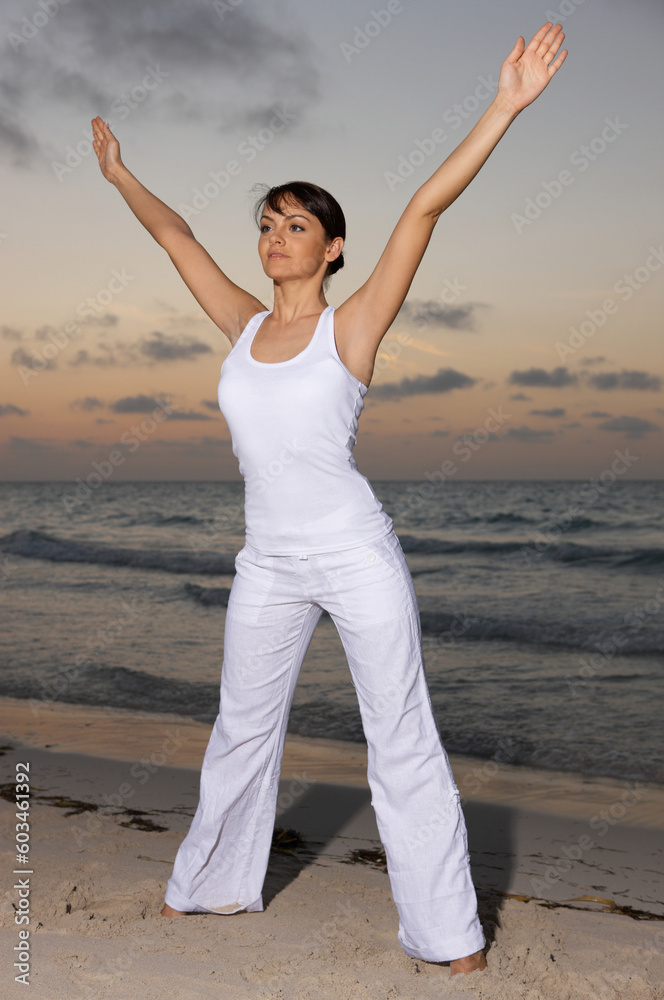 Young beautiful woman during fitness on sea beach Young beautiful woman during fitness on sea beach
