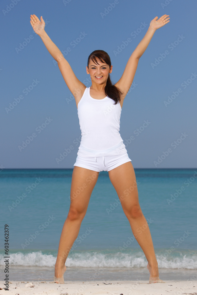 Young beautiful woman during fitness on sea beach Young beautiful woman during fitness on sea beach