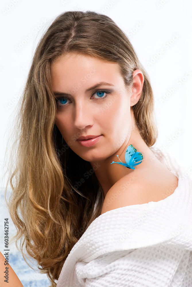 blond girl with blue eyes and a butterfly on her shoulder