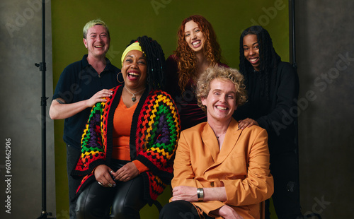 Portrait of five cheerful LGBTQIA queer people against studio backdrop for pride month