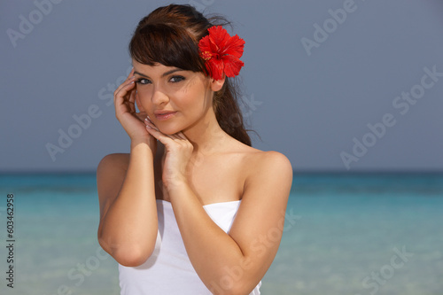 Young beautiful woman posing on sea beach