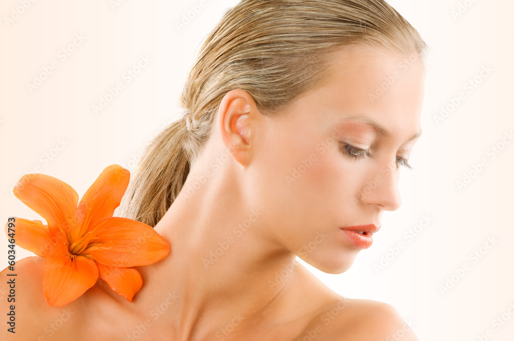 great portrait of a blond girl with an orange flower on her shoulder great portrait of a blond girl with an orange flower on her shoulder