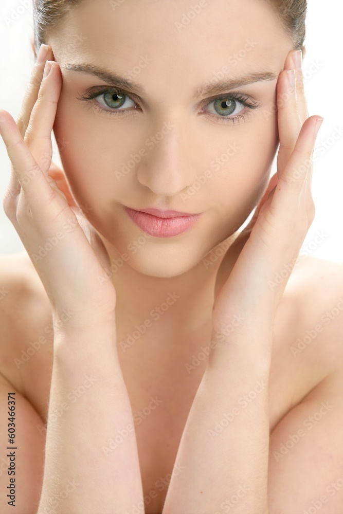 Beautiful woman portrait with hands on head isolated on white at studio