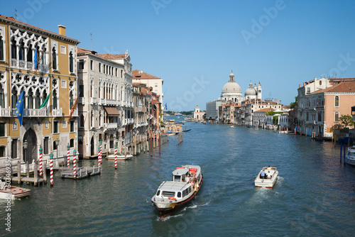 Boats on a canal surrounded by old world buildings in Venice  Italy. Horizontal shot.