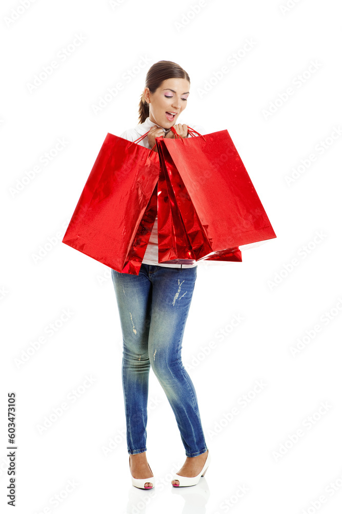 Beautiful young woman with red shopping bags. Consumerism Concept Beautiful young woman with red shopping bags. Consumerism Concept