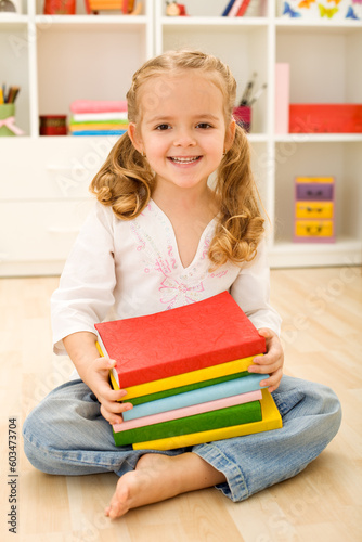 Happy little girl with books - preparing for school