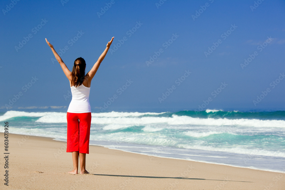 Beautiful young woman making Yoga exercises on the beach Beautiful young woman making Yoga exercises on the beach