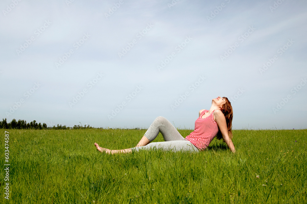 Young woman relaxing on a beautiful green meadow Young woman relaxing on a beautiful green meadow