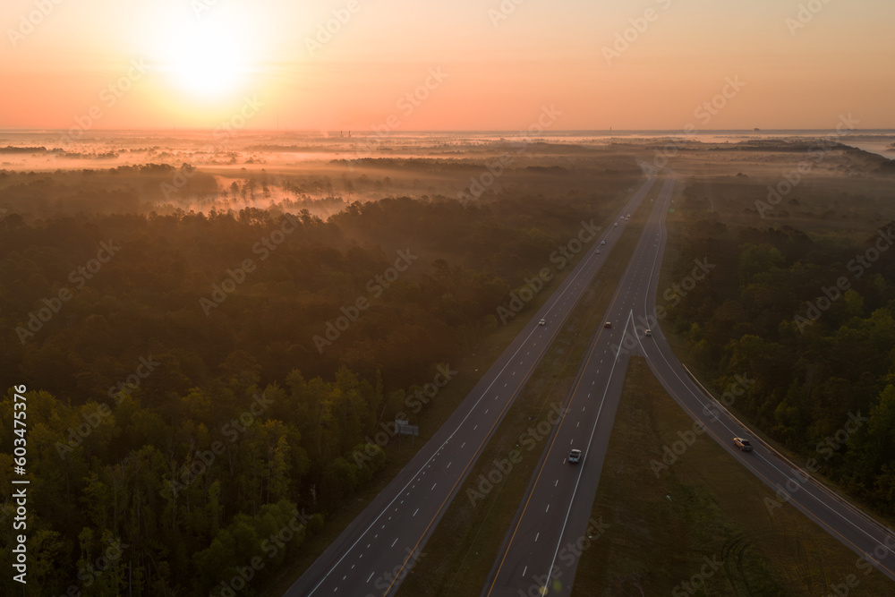 A highway with a sunset in the background