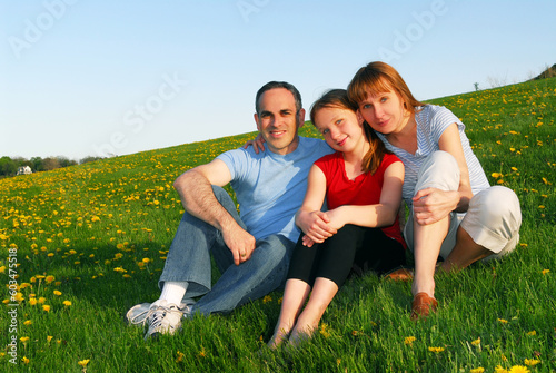 Portrait of a happy family of three on blooming summermedow © Designpics