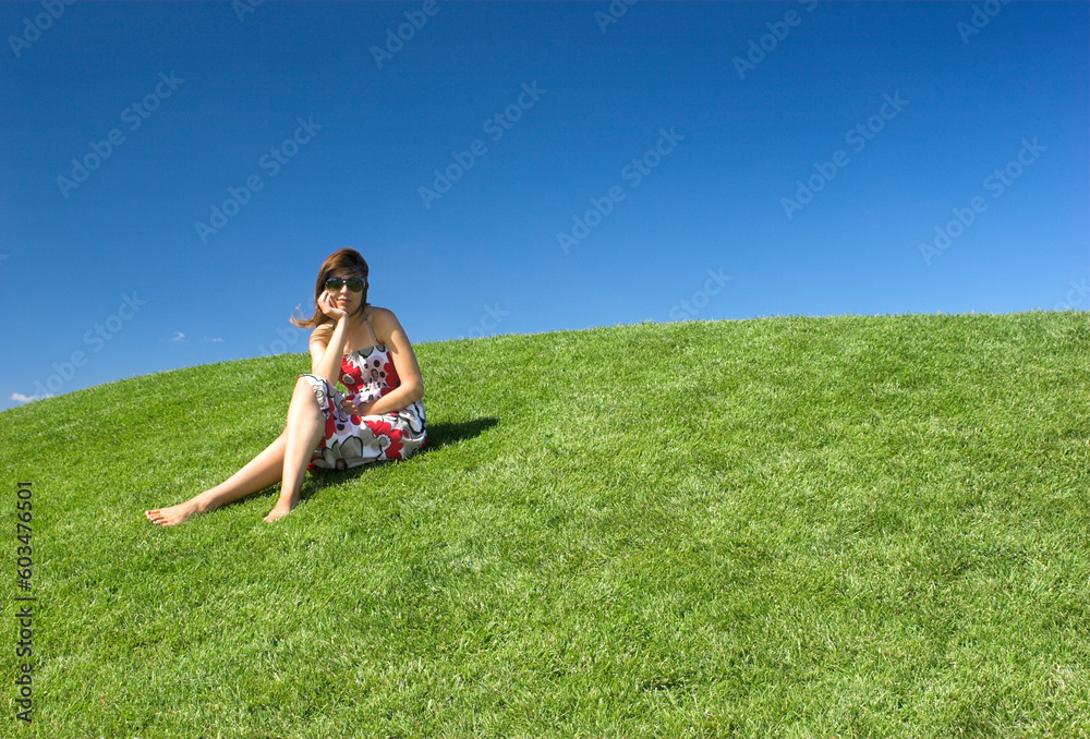 Beautiful woman relaxing on a beautiful green field Beautiful woman relaxing on a beautiful green field