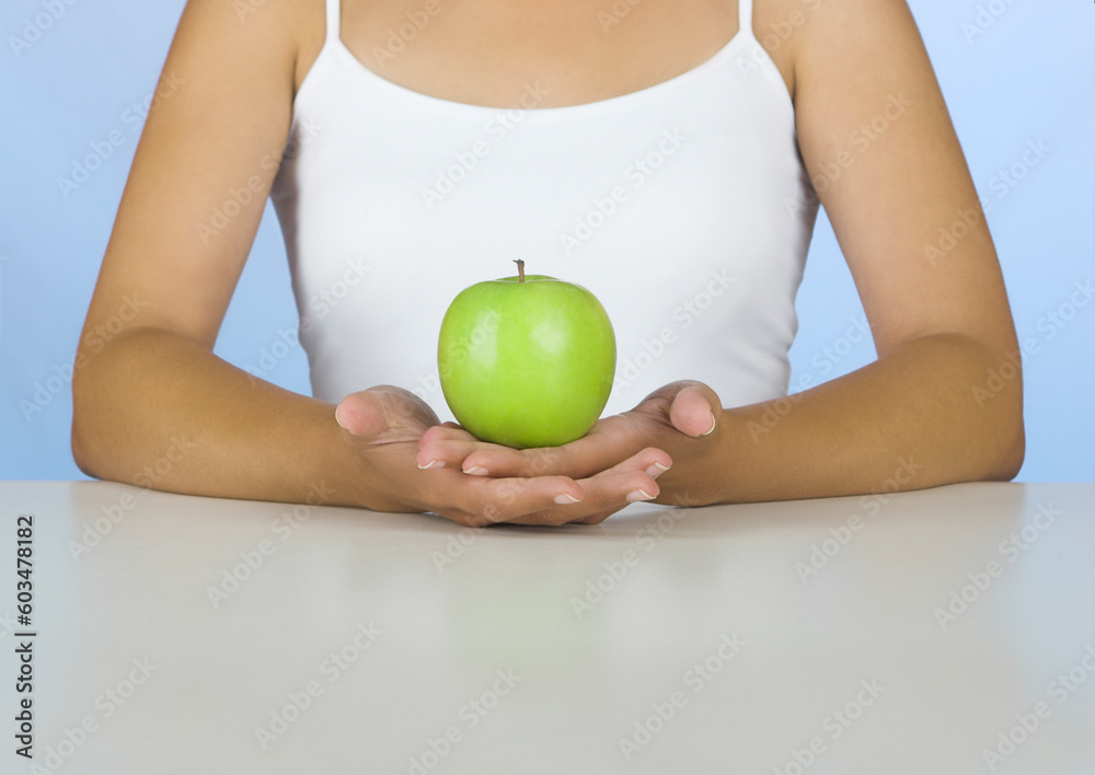 Picture of a Woman holding a green apple Picture of a Woman holding a green apple