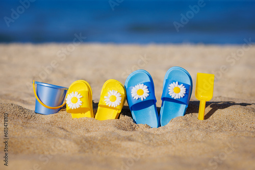 Childrens flip-flops on the beach. Summer vacation concept
