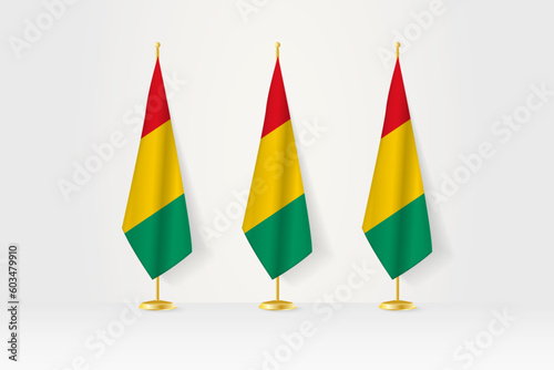 Three Guinea flags in a row on a golden stand, illustration of press conference and other meetings.
